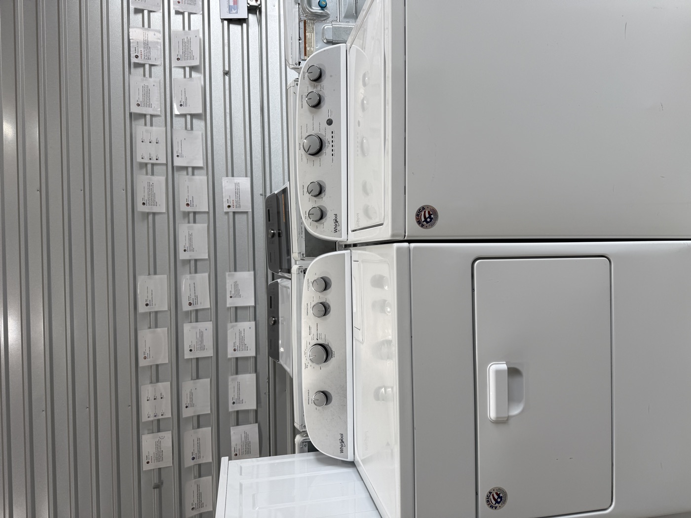Whirlpool washer and dryer set at Longhorn, backed by a wall of five-star customer reviews